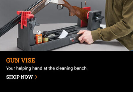 Person using a Hoppe's Gun Vise to clean a shotgun