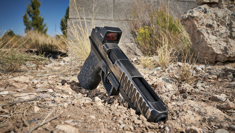 Bushnell RXS-250 Reflex Sight mounted on a pistol that's on the ground