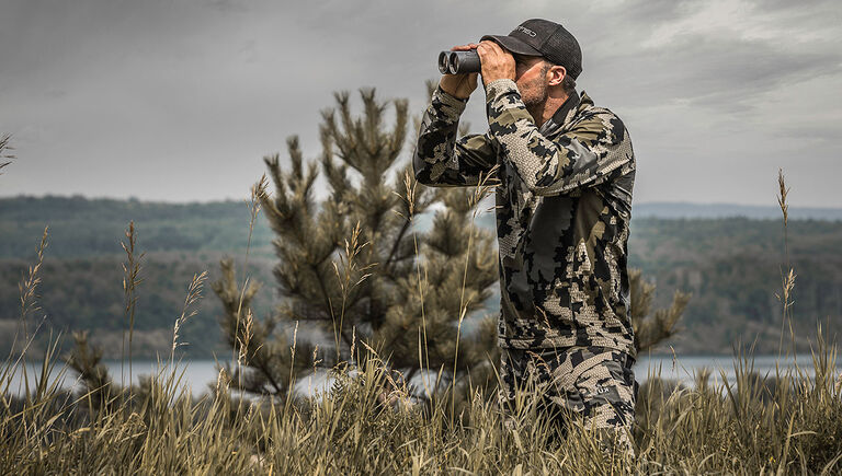 Hunter looking through the Bushnell Engage DX Binoculars