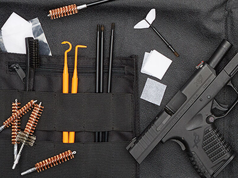 Handgun laid out on a Hoppe's Range Kit with Cleaning Mat